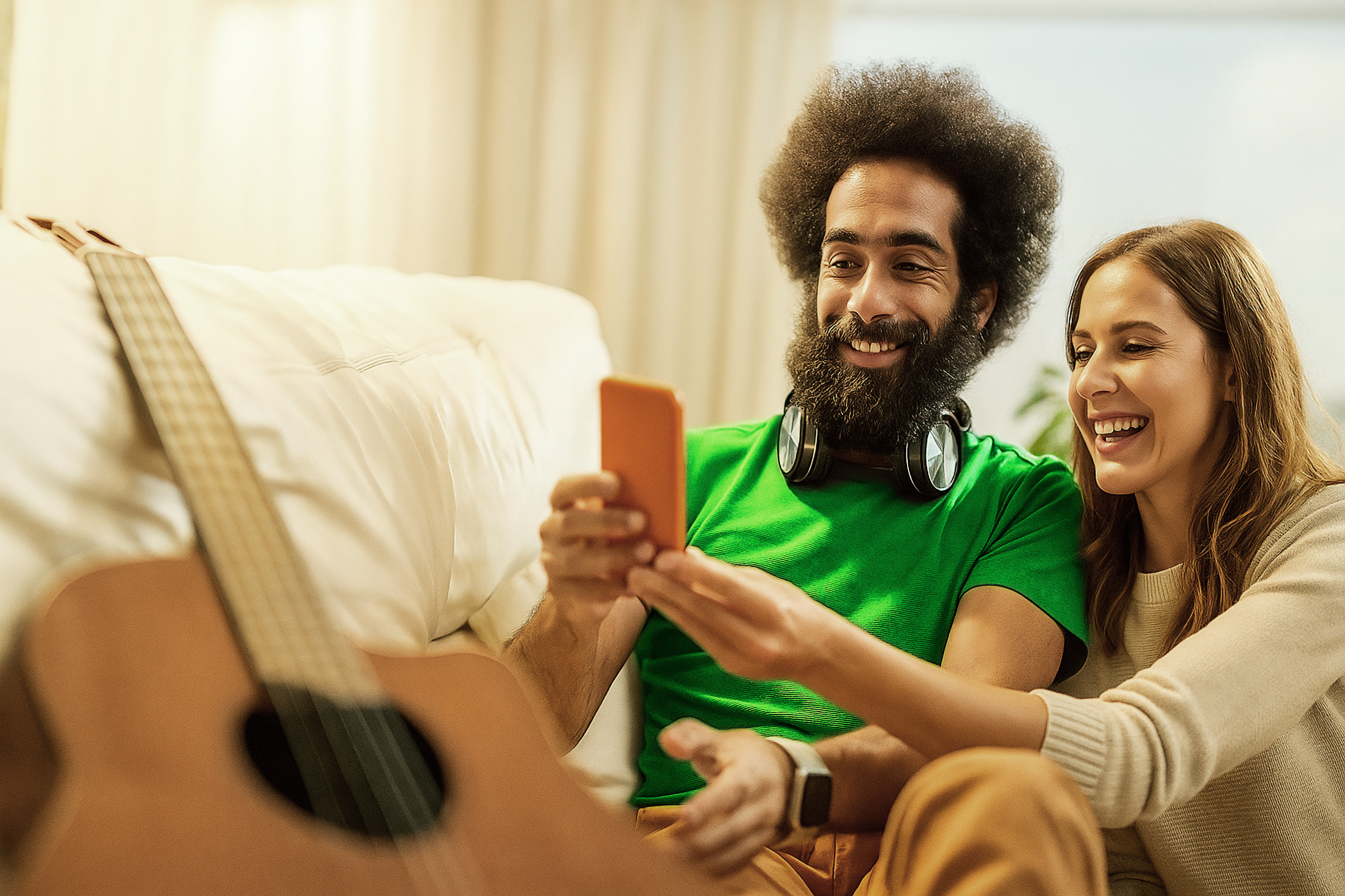 Couple using the Swopli app on a sofa